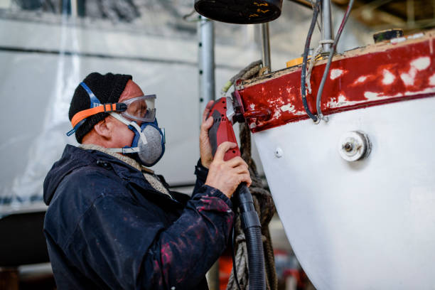 istock Man using grinding machine, maintenance of sailing yacht in boathouse 1093591082