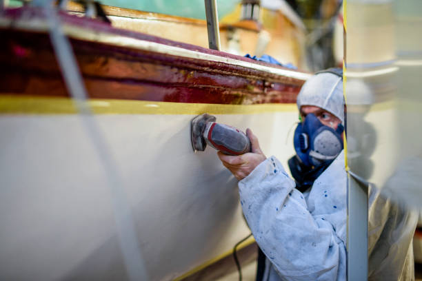 istock Man using grinding machine, maintenance of sailing yacht in boathouse 1093592698