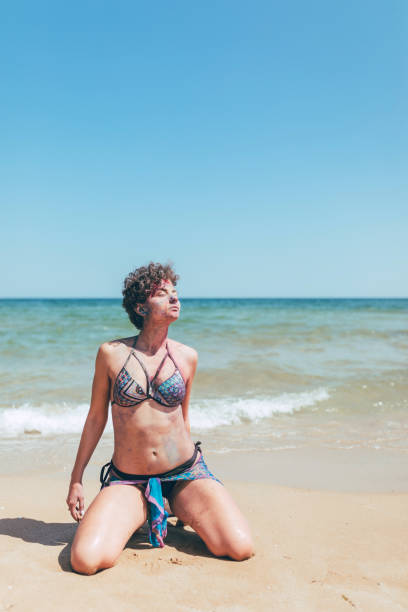 istock Woman with body paint on the beach 1093592714