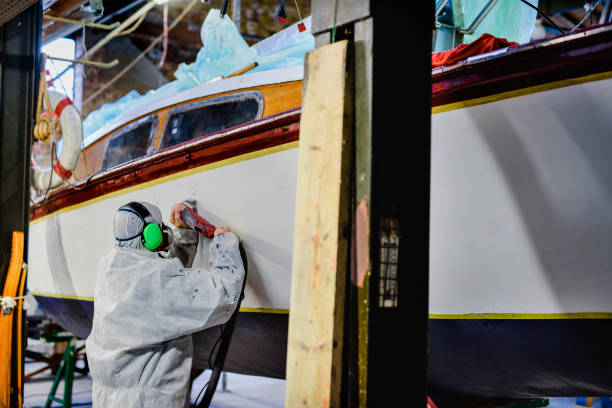 istock Man using grinding machine, maintenance of sailing yacht in boathouse 1093593280