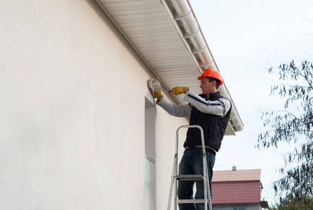 istock electrician mounts a wall lamp 1093593440