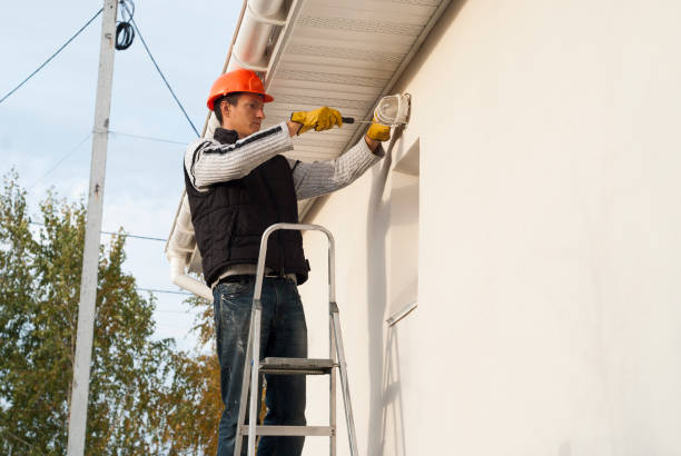 istock electrician mounts a wall lamp 1093593452