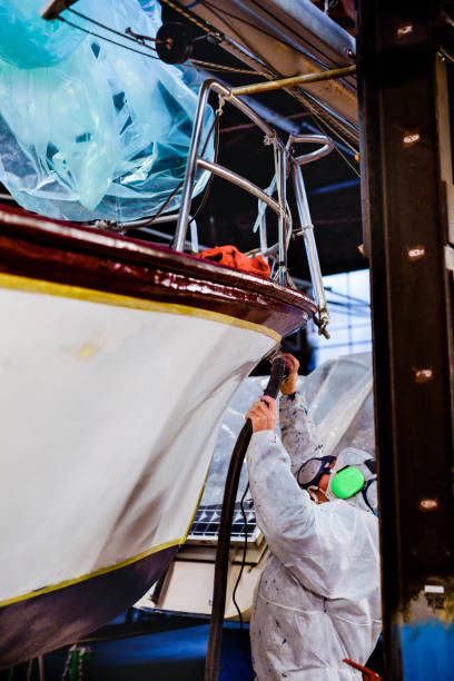 istock Man using grinding machine, maintenance of sailing yacht in boathouse 1093596788
