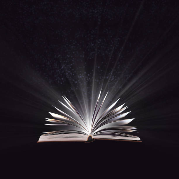 istock Open magic book, bewitched book glows in the darkness, magic light. Education. Dreamy image of a fairytale 1093599438