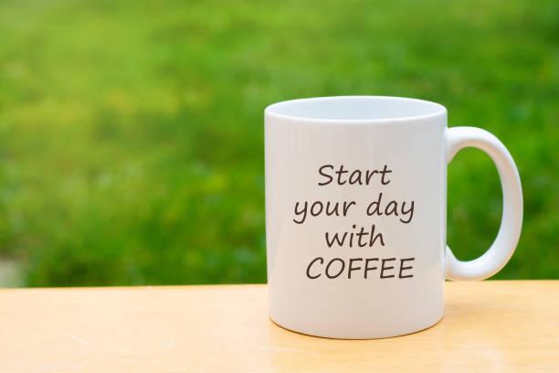 istock White porcelain mug cup isolated on green grass background with copy space. Coffee or tea cup. 1093602184