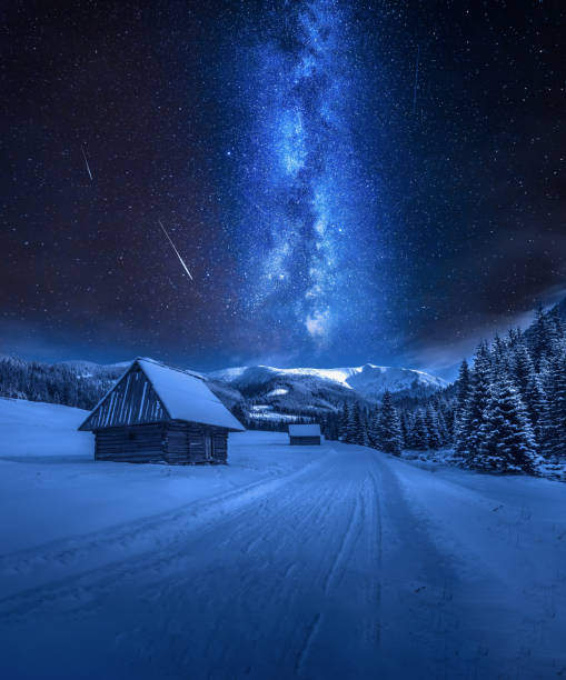 Milky way over snowy road in Tatra Mountains, Poland stock photo