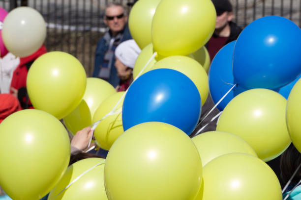 istock colorful bouncing balls outdoors against blue sunny sky . 1093605430