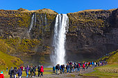Skogafoss waterfall in South Iceland overcrowded by tourists.
