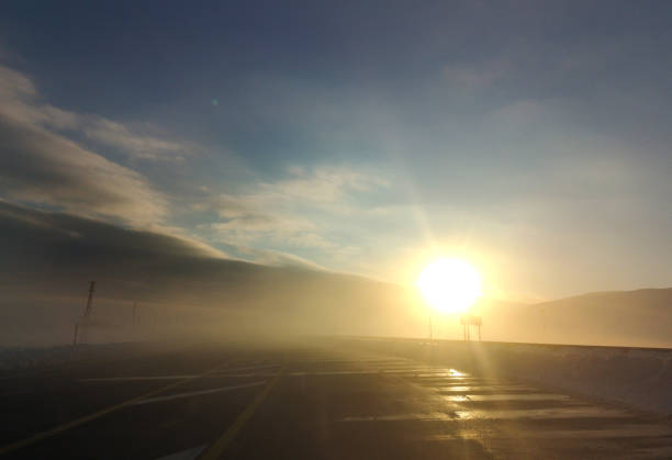 Winter misty highway road in morning sunlight