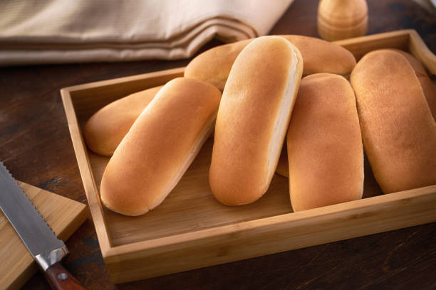 istock Fresh hot dog buns on a wooden surface 1093607848