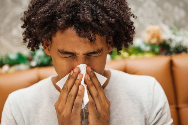 istock Sick Young Man Wiping His Nose 1093608064