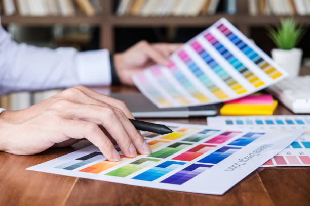 istock Image of male creative graphic designer working on color selection and drawing on graphics tablet at workplace with work tools and accessories 1093609986