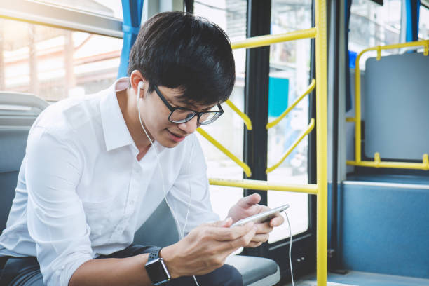 istock Young Asian man traveler sitting on a bus using smartphone watch video or playing game while smile of happy, transport, tourism and road trip concept 1093610162