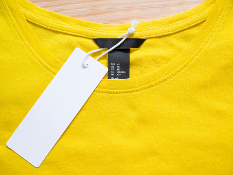 Blank price tag label on yellow t-shirt