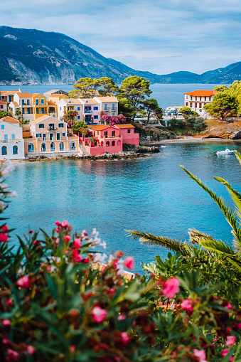 Beautiful view of Assos village with vivid colorful houses near blue turquoise colored and transparent bay lagoon. Kefalonia, Greece.