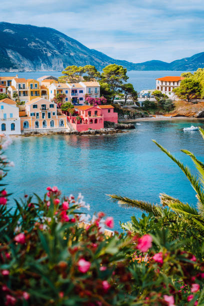Beautiful view of Assos village with vivid colorful houses near blue turquoise colored and transparent bay lagoon. Kefalonia, Greece Beautiful view of Assos village with vivid colorful houses near blue turquoise colored and transparent bay lagoon. Kefalonia, Greece. zakynthos stock pictures, royalty-free photos & images