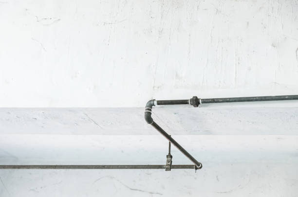 istock Old metal pipe on the white wall. 1093611742