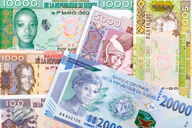 Photo of Guinean money a background