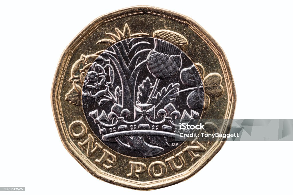 New one pound coin New one pound coin of England UK introduced in 2017 which show emblems of each of the nations cut out and isolated on a white background One Pound Coin Stock Photo