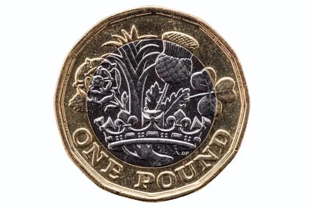 New one pound coin of England UK introduced in 2017 which show emblems of each of the nations cut out and isolated on a white background