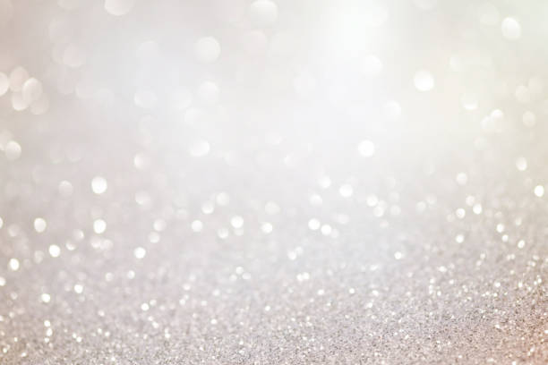 festive bokeh glowing background festive bokeh glowing background, abstract sparkling lights silver metal stock pictures, royalty-free photos & images