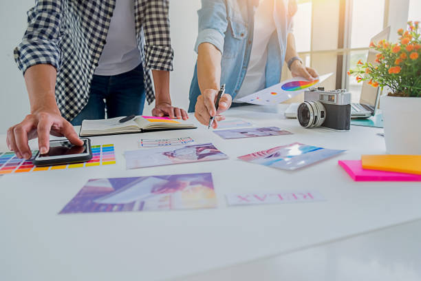 istock Asian advertising designer creative start-up team discussing ideas in office. 1093622698