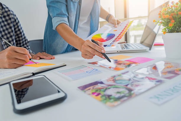 istock Asian advertising designer creative start-up team discussing ideas in office. 1093622710