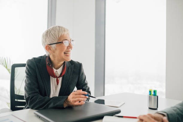 istock Older business woman smiling 1093624440