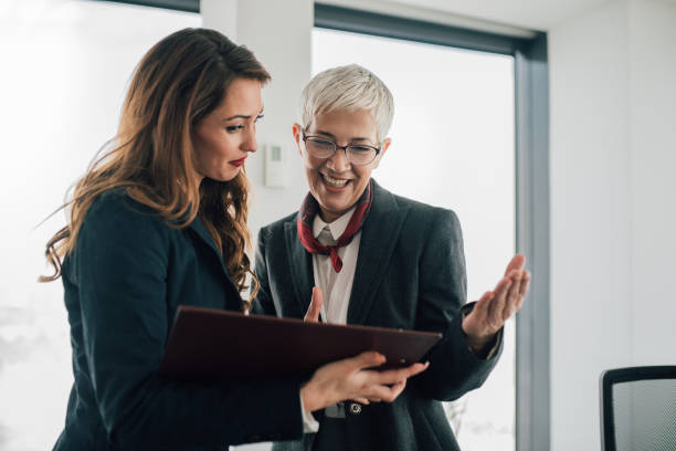 istock Smiling coworkers revising paperwork 1093627298
