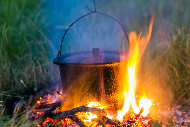 istock Camping kitchenware - pot on the fire at an outdoor campsite 1093638304