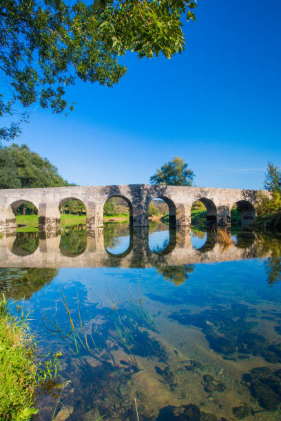 istock Croatia, Dobra river, old stone bridge 1093640282