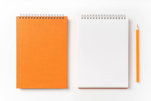 istock Top view of orange spiral notebook, page, pencil 1093644016