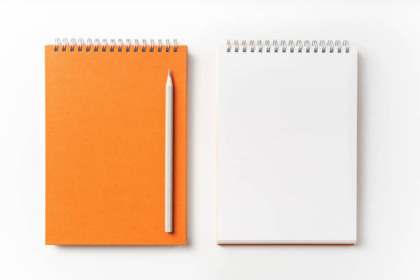 istock Top view of orange spiral notebook, page, pencil 1093644118