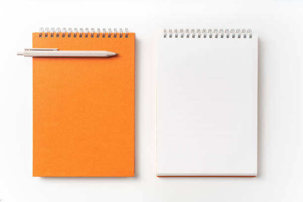 istock Top view of orange spiral notebook, page, pencil 1093644362