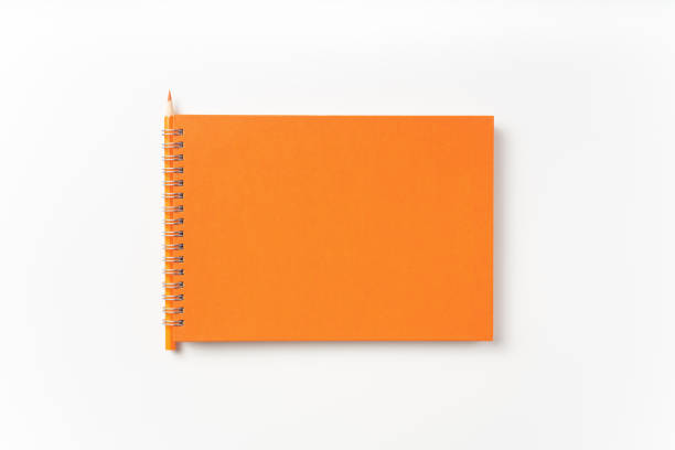 istock Top view of orange spiral notebook, page, pencil 1093644636