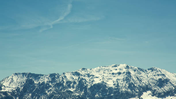 Retro styled snowcapped mountain range with copy space / Tyrol, Austria.