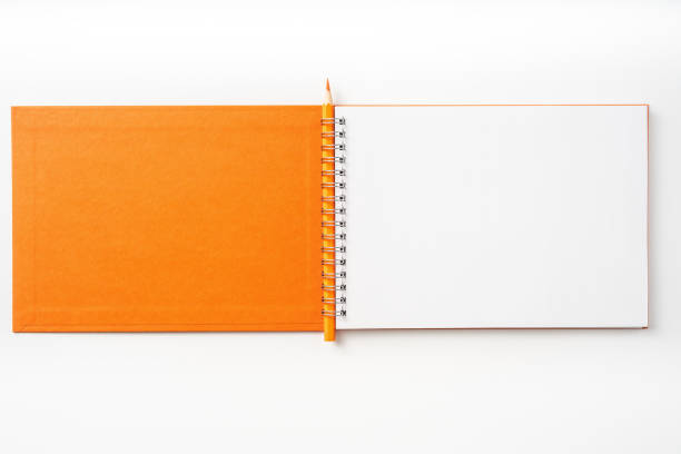 istock Top view of orange spiral notebook, page, pencil 1093645526