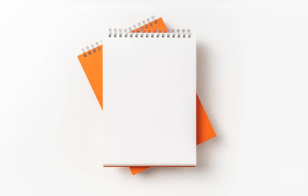 istock Top view of orange spiral notebook, page, pencil 1093646428