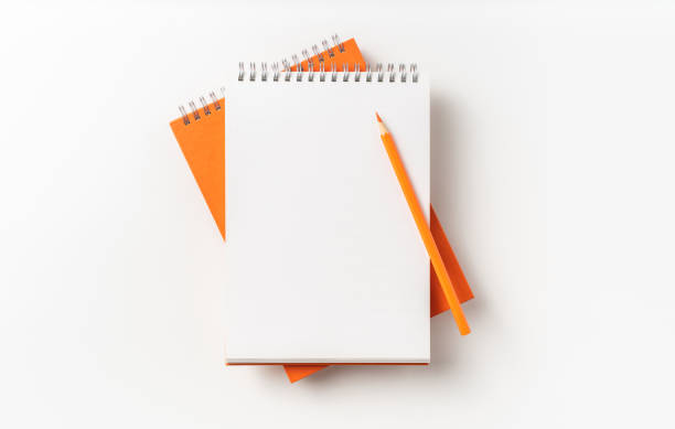 istock Top view of orange spiral notebook, page, pencil 1093646954