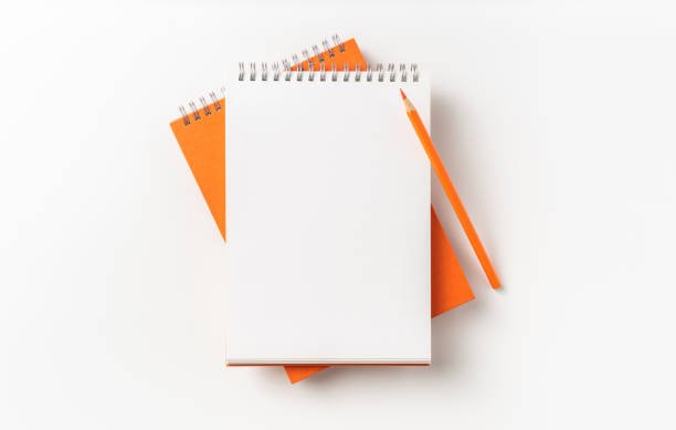 istock Top view of orange spiral notebook, page, pencil 1093647024