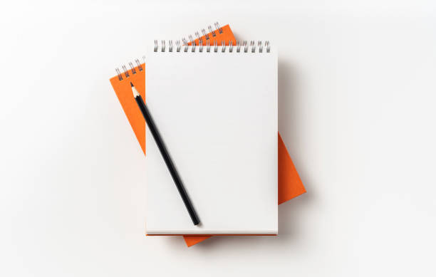 istock Top view of orange spiral notebook, page, pencil 1093647062