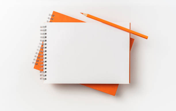 istock Top view of orange spiral notebook, page, pencil 1093647202
