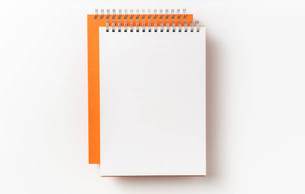 istock Top view of orange spiral notebook, page, pencil 1093647444