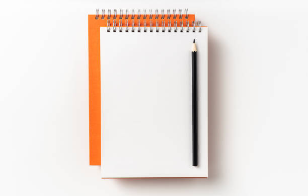 istock Top view of orange spiral notebook, page, pencil 1093647666