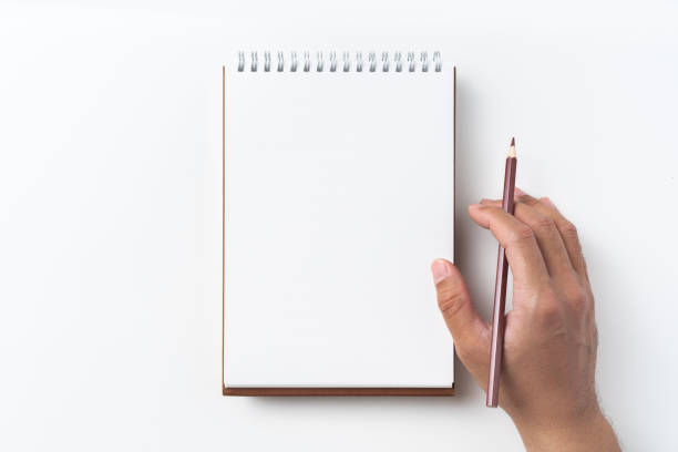 istock Top view of brown spiral notebook with hand 1093648252