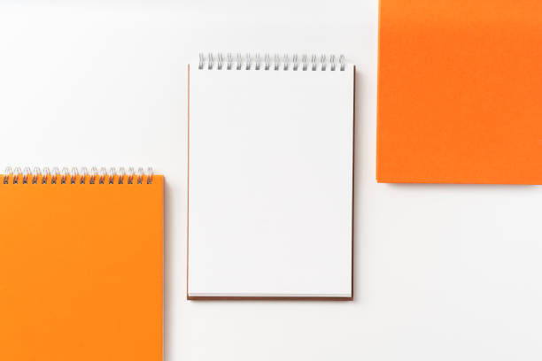 istock Top view of orange spiral notebook, page 1093650664