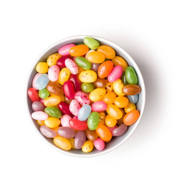 Sweet jelly beans Sweet jelly beans in bowl isolated on white background. jellybean photos stock pictures, royalty-free photos & images
