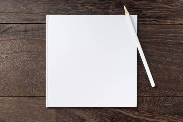 istock Top view of white hardcover notebook, pencil 1093651000