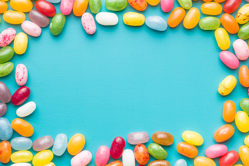 Sweet jelly beans on blue background.