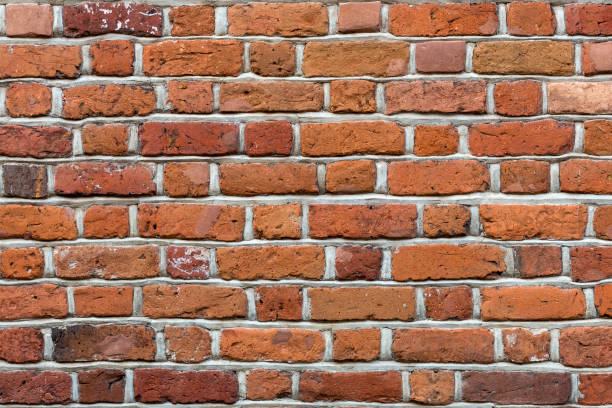 istock Natural old vintage weathered red brown solid brick wall. Abstract copy space background. 1093651610